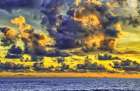 Golden light of swirling clouds sunset reflects a pink glow on the beach at Pererenan Beach-Bali Art Print